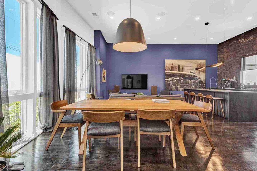 Custom Atlanta home with Philux chairs, wood table, and sleek modern kitchen design.