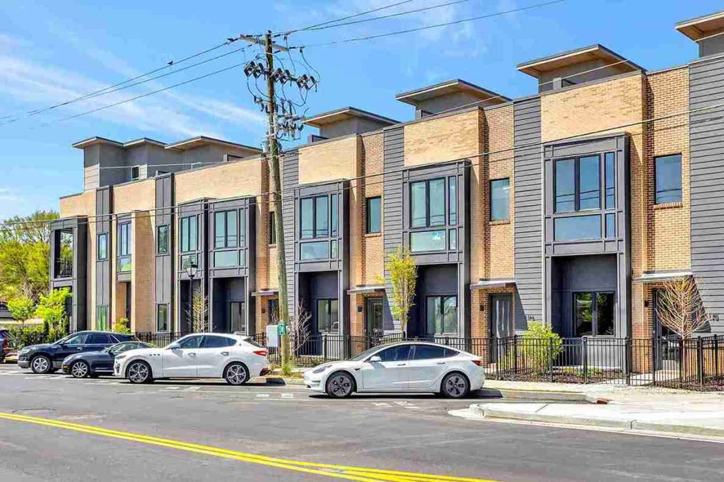 Row of luxury townhomes by Atlanta GA builders, featuring modern design and brick.